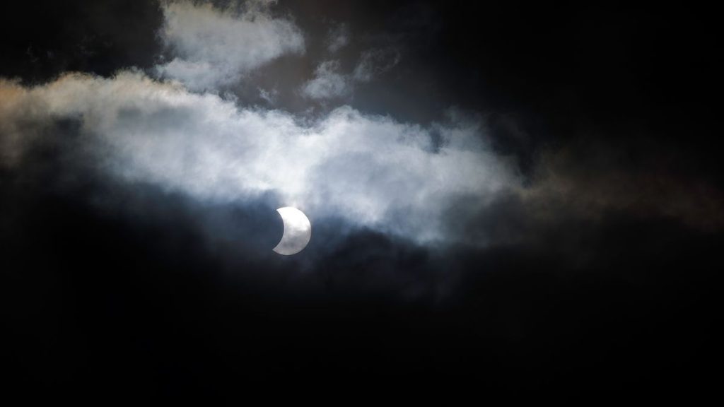 Why low-level clouds vanish during a solar eclipse